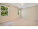 Bedroom with neutral carpet and multiple windows providing ample natural light and a ceiling fan at 216 Homestretch Blvd, Deland, FL 32724