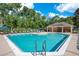 Inviting community pool featuring a covered lounge area with tables and chairs at 216 Homestretch Blvd, Deland, FL 32724