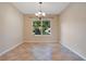 Empty dining room with tile floors and lots of natural light from the window at 216 Homestretch Blvd, Deland, FL 32724