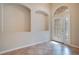 Inviting entryway featuring tile floors, two archway shelves, and a decorative glass front door with sidelights at 216 Homestretch Blvd, Deland, FL 32724