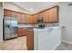 Bright kitchen boasts stainless steel appliances, wooden cabinets, granite counters and tiled backsplash at 216 Homestretch Blvd, Deland, FL 32724