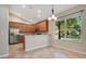 Bright kitchen featuring stainless steel appliances, wooden cabinets, granite counters, a breakfast bar and a dining area at 216 Homestretch Blvd, Deland, FL 32724
