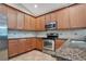 The kitchen boasts custom cabinets, stainless appliances and granite counters at 216 Homestretch Blvd, Deland, FL 32724