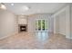 Spacious living room featuring tile floors, fireplace, and French doors to the exterior at 216 Homestretch Blvd, Deland, FL 32724
