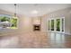 Spacious living area with natural light, cozy fireplace, and double glass doors at 216 Homestretch Blvd, Deland, FL 32724