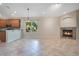 Open concept living area with cozy fireplace, lots of natural light, and tile flooring at 216 Homestretch Blvd, Deland, FL 32724