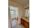 Functional bathroom featuring tiled floors, shower-tub combo, and wooden vanity at 2200 San Vittorino Cir # 102, Kissimmee, FL 34741