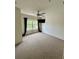 Bedroom showcasing a window, ceiling fan, and neutral carpet at 2200 San Vittorino Cir # 102, Kissimmee, FL 34741