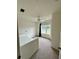 Neutral-toned bedroom with a window, fan and a comfortable white bed at 2200 San Vittorino Cir # 102, Kissimmee, FL 34741