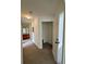 Hallway featuring carpet, lighting, with the bathroom at the end at 2200 San Vittorino Cir # 102, Kissimmee, FL 34741