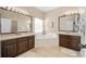 This bathroom features dual sinks, a soaking tub, and tile flooring at 253 Clydesdale Cir, Sanford, FL 32773