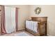 This Bedroom showcases a crib and floral decor, creating a serene and inviting atmosphere at 253 Clydesdale Cir, Sanford, FL 32773