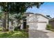 Charming home featuring a two-car garage, manicured lawn, and whimsical swing at 253 Clydesdale Cir, Sanford, FL 32773