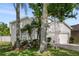 Charming home featuring a two-car garage and lush, landscaped front yard at 253 Clydesdale Cir, Sanford, FL 32773