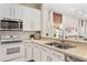 Kitchen view showcasing the white cabinets, stainless steel appliances, and breakfast bar at 253 Clydesdale Cir, Sanford, FL 32773