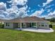 Aerial view of the home's backyard with covered patio, stone pavers, and manicured lawn at 2781 Sand Oak Loop, Apopka, FL 32712