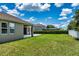 Expansive backyard with lush lawn, privacy fence, and covered patio at 2781 Sand Oak Loop, Apopka, FL 32712
