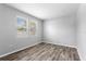 Bedroom featuring gray wood floors and two windows at 2781 Sand Oak Loop, Apopka, FL 32712