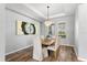 Bright dining area with wood floors, tray ceiling, chandelier, and lots of natural light at 2781 Sand Oak Loop, Apopka, FL 32712