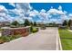 Entrance to a well-maintained community with stone signage and manicured landscaping at 2781 Sand Oak Loop, Apopka, FL 32712
