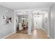 Open-concept foyer leading to a dining room with wood floors and an elegant chandelier at 2781 Sand Oak Loop, Apopka, FL 32712