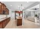 Spacious kitchen with stainless steel appliances and granite countertops, flowing into the living area at 2781 Sand Oak Loop, Apopka, FL 32712