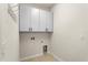 Laundry room featuring washer/dryer hookups, storage cabinets, and tile flooring at 2781 Sand Oak Loop, Apopka, FL 32712