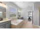 Elegant main bathroom boasts a soaking tub, dual vanities, and an open doorway to main bedroom at 2781 Sand Oak Loop, Apopka, FL 32712
