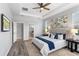 Spacious main bedroom with a tray ceiling, fan, and access to the main bathroom at 2781 Sand Oak Loop, Apopka, FL 32712