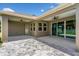 Covered patio with ceiling fans and stone pavers provides a great space for outdoor entertaining at 2781 Sand Oak Loop, Apopka, FL 32712