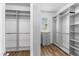 Spacious walk-in closet featuring custom shelving and a small chest of drawers at 2781 Sand Oak Loop, Apopka, FL 32712