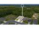 Drone shot of a newly built home community with a lake and dense trees at 3984 Mayhill Loop, Eustis, FL 32736