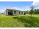 Expansive backyard with a covered patio, ideal for outdoor dining and entertainment at 3984 Mayhill Loop, Eustis, FL 32736