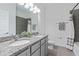 Bathroom featuring double sinks, granite countertop, tiled shower and floors and modern lighting at 3984 Mayhill Loop, Eustis, FL 32736