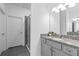 Bathroom with granite countertops, gray cabinetry and an enclosed shower at 3984 Mayhill Loop, Eustis, FL 32736