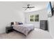 Bedroom featuring a ceiling fan, patterned bedspread, bedside tables, dresser, and a window at 3984 Mayhill Loop, Eustis, FL 32736