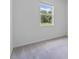 Bright bedroom featuring a window with serene views and neutral carpet at 3984 Mayhill Loop, Eustis, FL 32736