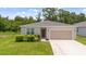 Charming single-story home with a well-maintained lawn, lush landscaping, and a neutral color palette at 3984 Mayhill Loop, Eustis, FL 32736