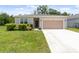 Charming single-story home with a well-manicured lawn and a two-car garage at 3984 Mayhill Loop, Eustis, FL 32736