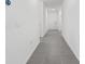 A clean, bright hallway with tile flooring leads to bedrooms and living areas, offering seamless transition and style at 3984 Mayhill Loop, Eustis, FL 32736