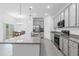 This modern kitchen offers granite countertops, stainless-steel appliances, and an open layout for easy entertaining at 3984 Mayhill Loop, Eustis, FL 32736