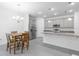 The modern kitchen features gray cabinets, granite countertops, stainless steel appliances, and a cozy breakfast nook at 3984 Mayhill Loop, Eustis, FL 32736