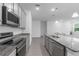 The updated kitchen boasts sleek stainless-steel appliances and granite counters, with an island for casual dining at 3984 Mayhill Loop, Eustis, FL 32736