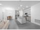 Open kitchen with gray cabinets, stainless steel appliances, granite countertops and tile flooring at 3984 Mayhill Loop, Eustis, FL 32736