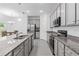 The modern kitchen boasts granite countertops, stainless appliances, and an open design for entertaining and everyday living at 3984 Mayhill Loop, Eustis, FL 32736