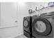 Functional laundry room with modern washer and dryer, shelving and ample storage space at 3984 Mayhill Loop, Eustis, FL 32736