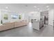 An open-concept design integrates the kitchen, dining, and living areas, enhanced by natural light and modern finishes at 3984 Mayhill Loop, Eustis, FL 32736