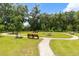 Scenic park area with winding paths, lush greenery, and inviting benches at 3984 Mayhill Loop, Eustis, FL 32736