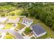 Aerial view of the property shows lush surroundings and advantageous placement within a desirable neighborhood at 4064 Sunny Day Way, Kissimmee, FL 34744