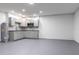Finished basement area features gray cabinets, epoxy flooring, and a neutral color palette for versatile use at 4064 Sunny Day Way, Kissimmee, FL 34744